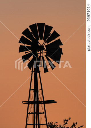 Windmill Sunset with a colorful sky and the Sun Windmill Sunset with a colorful sky and the Sun 93971014