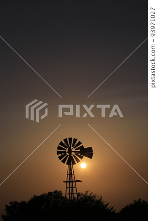 Windmill Sunset with a colorful sky and the Sun Windmill Sunset with a colorful sky and the Sun 93971027