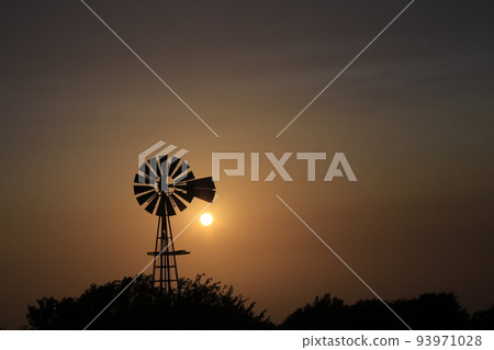 Windmill Sunset with a colorful sky and the Sun Windmill Sunset with a colorful sky and the Sun 93971028