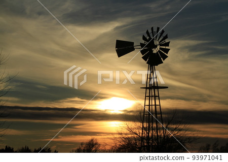 Windmill Sunset with a colorful sky and the Sun Windmill Sunset with a colorful sky and the Sun 93971041