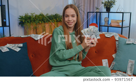 Successful happy rich business woman counting money cheering up with high profits, lottery game win Successful happy rich business woman counting money cheering up with high profits, lottery game win 93971567