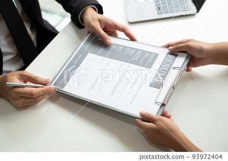 Business people hold a resume and talk to job applicants for job interviews about careers and Their personal history in the company. Recruitment concepts Business people hold a resume and talk to job applicants for job interviews about careers and Their personal history in the company. Recruitment concepts 93972404