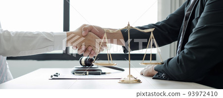 shake hand Professional man lawyers work at a law office There are scales, Scales of justice, judges gavel, and litigation documents. Concepts of law and justice 93972410