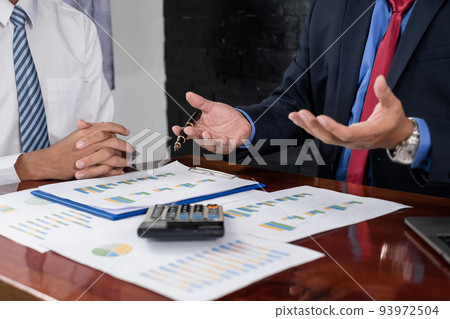 Two business leaders talk about charts, financial graphs showing results are analyzing and calculating planning strategies, business success building processes 93972504