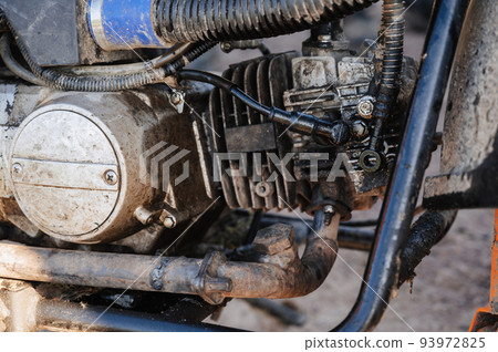 motor with a broken hose and leaking oil on sports off-road sports motorcycle 93972825