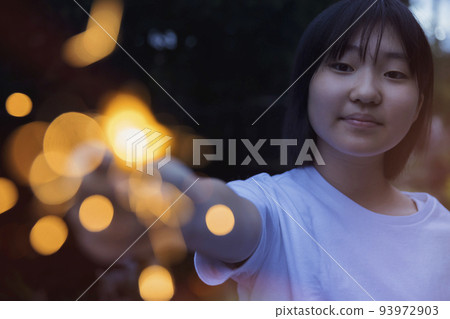 Children playing fireworks on hand 93972903