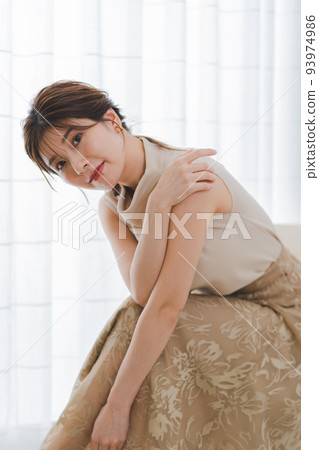 A young woman sitting on a chair 93974986