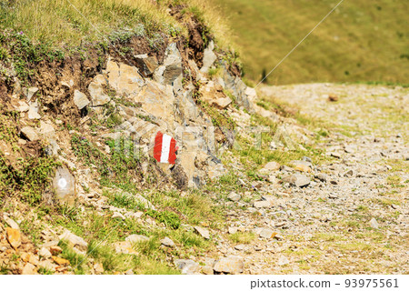 Red and White Trail Sign on a Stone - Footpath in Austrian Alps 93975561