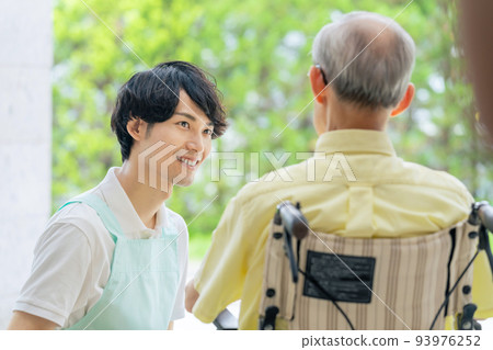 Elderly people in wheelchairs and care helpers 93976252