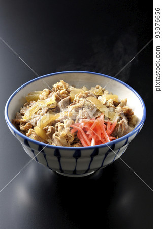A simple and hot beef bowl with red pickled ginger on a black background A simple and hot beef bowl with red pickled ginger on a black background 93976656
