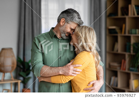 Mature Romance. Portrait Of Romantic Middle Aged Spouses Bonding At Home Mature Romance. Portrait Of Romantic Middle Aged Spouses Bonding At Home 93976927
