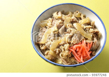 A bird's-eye view of a piping hot beef bowl topped with red pickled ginger 93977248