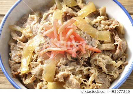 A bird's-eye view of a piping hot beef bowl topped with red pickled ginger A bird's-eye view of a piping hot beef bowl topped with red pickled ginger 93977269