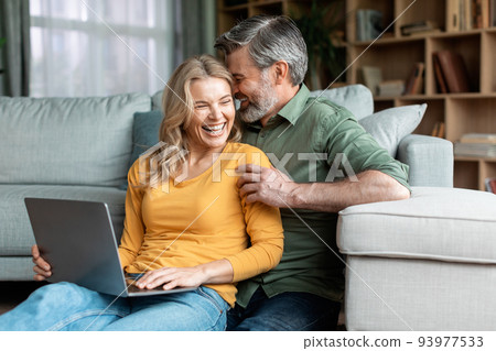 Happy Moments. Romantic Middle Aged Spouses Using Laptop And Bonding At Home 93977533