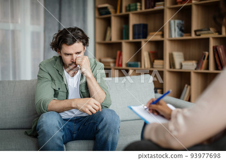 Despaired millennial european man client cry at meeting with black woman psychologist in office Despaired millennial european man client cry at meeting with black woman psychologist in office 93977698