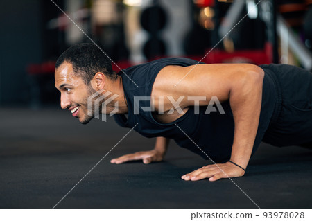 Muscular Young African American Man Doing Floor Push Up Exercise In Gym Muscular Young African American Man Doing Floor Push Up Exercise In Gym 93978028