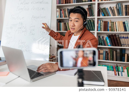 Chinese Tutor Having Lecture Via Video Call On Phone Indoors Chinese Tutor Having Lecture Via Video Call On Phone Indoors 93978141