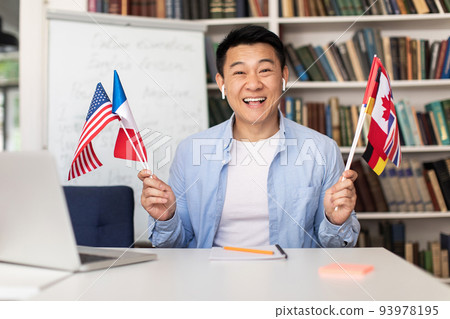Asian Language Teacher Man Holding Different Countries Flags Sitting Indoor 93978195
