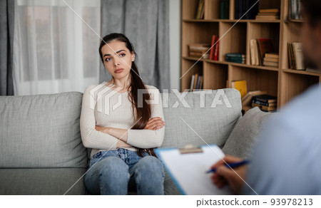 Melancholic sad european millennial woman patient look at male doctor, listen advice in clinic interior Melancholic sad european millennial woman patient look at male doctor, listen advice in clinic interior 93978213
