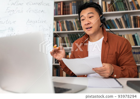 Asian Teacher Teaching Online Via Video Call On Laptop Indoor 93978294