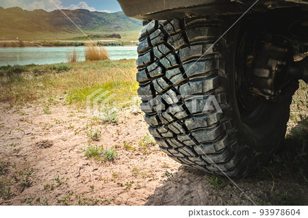 Big wheel 4x4 SUV with aggressive tread on a trip in the wild 93978604