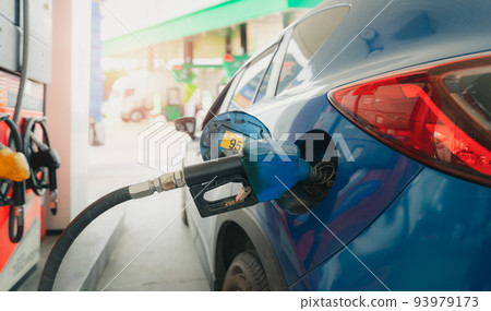 Car fueling at gas station. Refuel fill up with petrol gasoline. Petrol pump filling fuel nozzle in fuel tank of car at gas station. Petrol industry and service. Petrol price and oil crisis concept. 93979173
