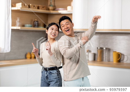 Crazy japanese couple having fun together at kitchen Crazy japanese couple having fun together at kitchen 93979397