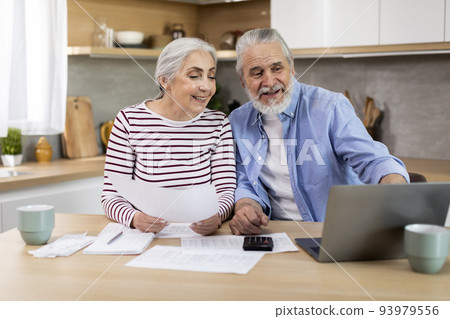 Happy Senior Spouses Making Family Budget Planning In Kitchen 93979556