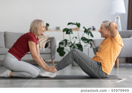Sporty mature couple having workout at home, copy space Sporty mature couple having workout at home, copy space 93979949
