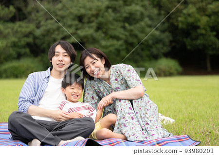 Family image sitting on a leisure seat in the park Family image sitting on a leisure seat in the park 93980201