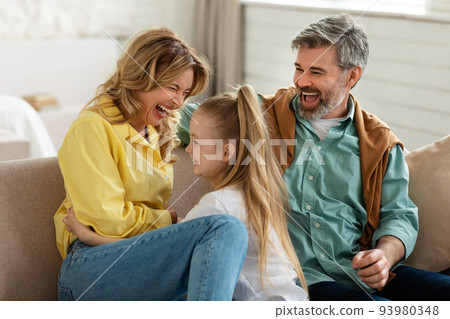 Family Having Fun Playing And Tickling Each Other At Home 93980348