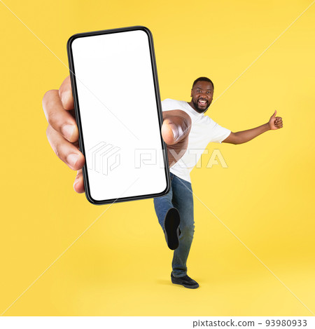 Cheerful Black Man Showing Cellphone Screen Over Yellow Background, Square 93980933
