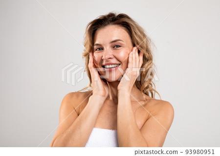 Antiage Skincare. Attractive Middle Aged Female Touching Face And Smiling At Camera 93980951