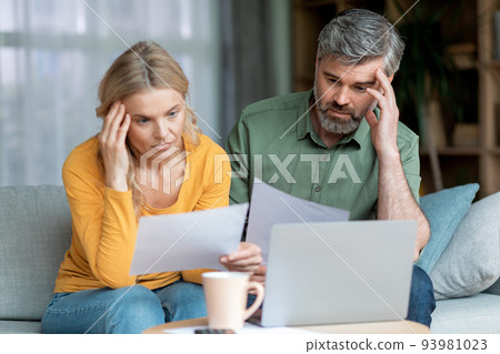 Financial Crisis. Pensive Middle Aged Couple Checking Documents At Home 93981023