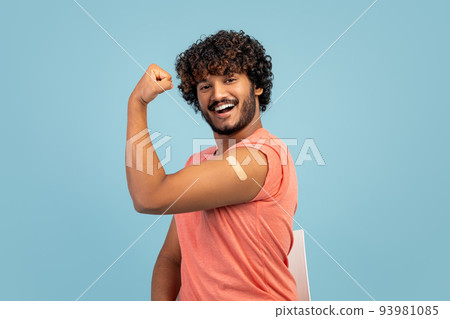Handsome indian man showing biceps with adhesive plaster on Handsome indian man showing biceps with adhesive plaster on 93981085