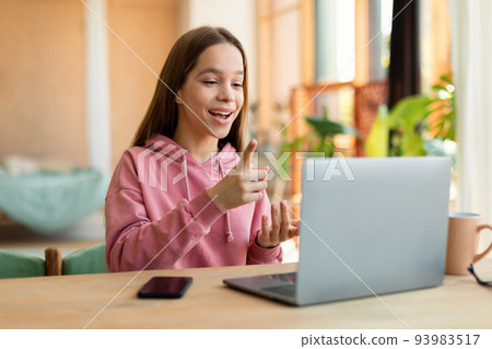 Smart girl teenager having video conference with teacher from home, using laptop and talking at webcamera Smart girl teenager having video conference with teacher from home, using laptop and talking at webcamera 93983517