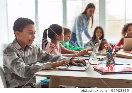 Cheerful Black Schoolboy Using Laptop Computer Learning Online In Classroom Cheerful Black Schoolboy Using Laptop Computer Learning Online In Classroom 93983519