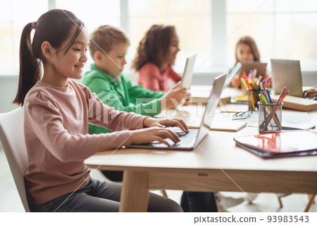 Asian Girl Using Laptop Sitting With Diverse Classmates In Classroom Asian Girl Using Laptop Sitting With Diverse Classmates In Classroom 93983543