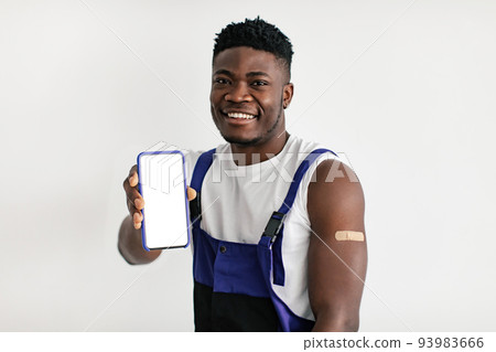 Happy Vaccinated African American Male Worker Showing Cellphone Screen, Studio 93983666