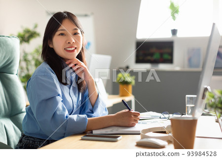 Japanese Businesswoman Using Computer Working Online Posing Sitting In Office Japanese Businesswoman Using Computer Working Online Posing Sitting In Office 93984528