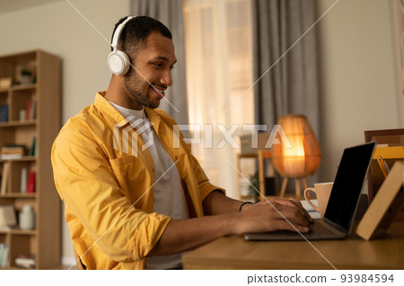 Online communication, remote job, web based learning. Young black guy speaking to colleague on laptop from home 93984594