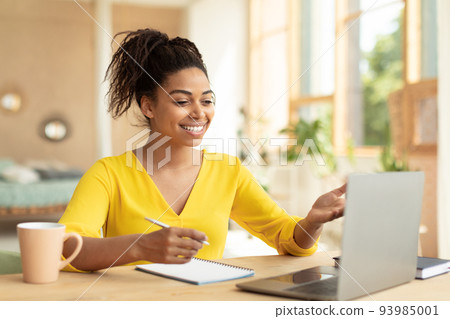 E-learning concept. Happy black female teacher having video chat with students, talking at laptop webcamera E-learning concept. Happy black female teacher having video chat with students, talking at laptop webcamera 93985001