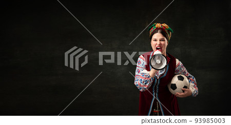Flyer with expressive young woman in national traditional folk Ukrainian attire shouting at megaphone isolated over dark vintage background. Sport, betting Flyer with expressive young woman in national traditional folk Ukrainian attire shouting at megaphone isolated over dark vintage background. Sport, betting 93985003