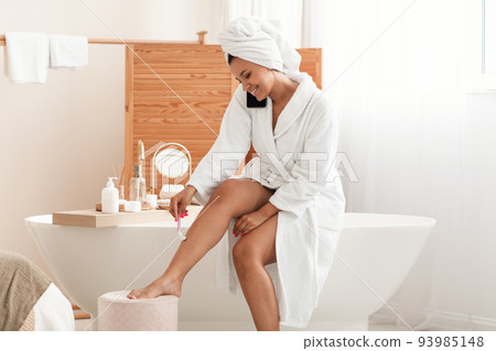 Woman Making Depilation Shaving Legs Talking On Phone In Bathroom Woman Making Depilation Shaving Legs Talking On Phone In Bathroom 93985148