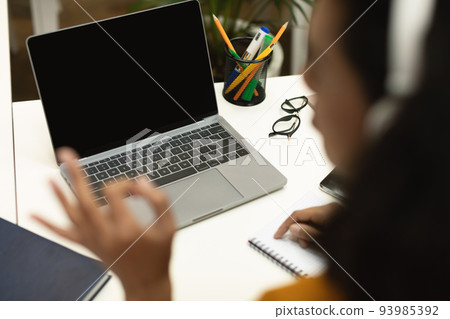 Black female teacher video calling via laptop and gesturing okay sign to computer empty screen, having online lesson 93985392