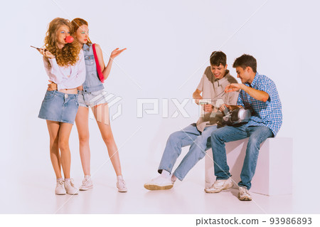 Groupf of young stylish people, students posing isolated over grey background. Jeans fashion. 93986893