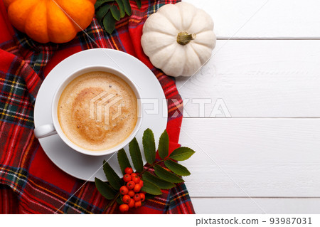 Cup of hot coffee with pumpkins 93987031