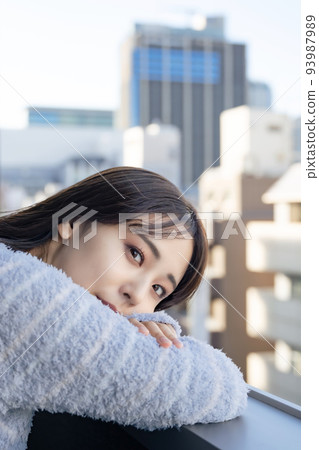A woman looking out on the veranda 93987989