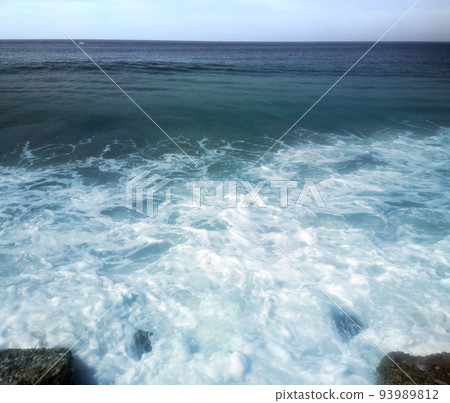 surf on shores of Indian ocean and overgrown with algae stones surf on shores of Indian ocean and overgrown with algae stones 93989812