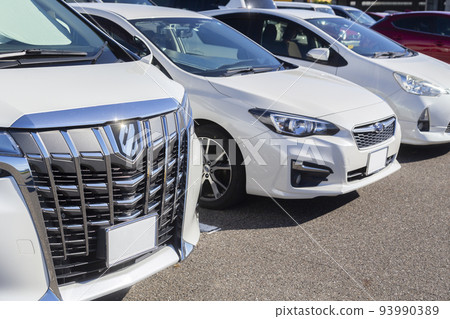 Cars lined up in a parking lot Cars lined up in a parking lot 93990389